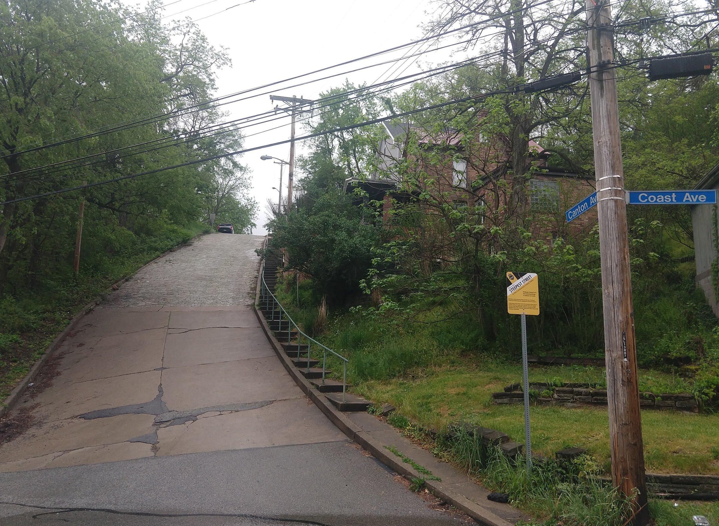 Canton Avenue rising on a block-paved slope beside steps, with Canton and Coast Avenue signs at the junction