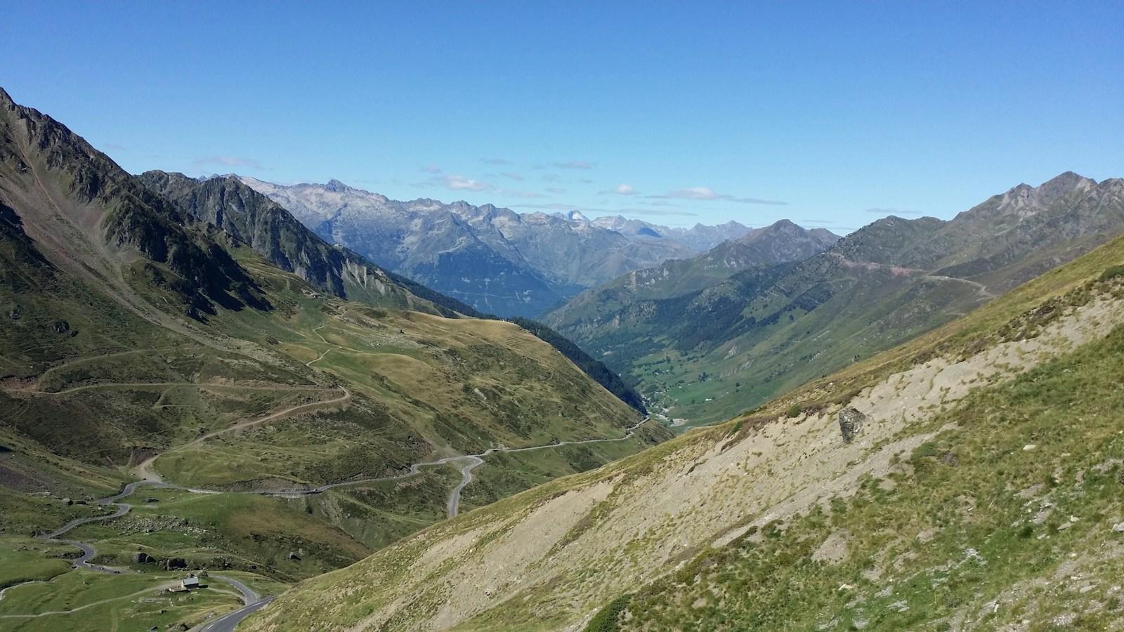A winding road climbing through open mountain slopes at the Col du Tourmalet